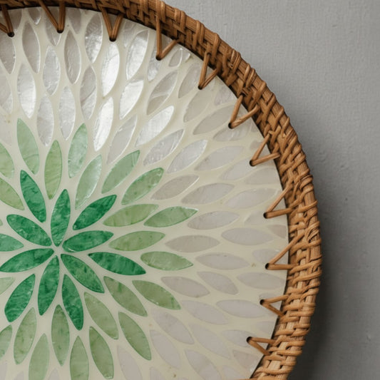 Close-up of green petal mother-of-pearl inlay and handwoven rattan rim