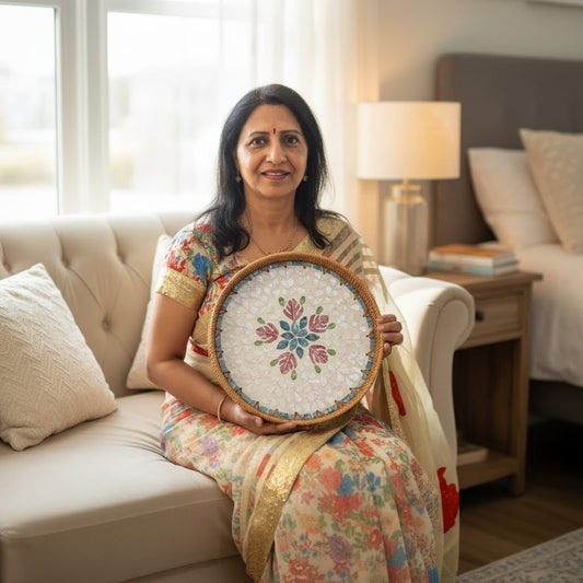 Round mother-of-pearl tray held on a sofa in a cozy living room, showing size and scale