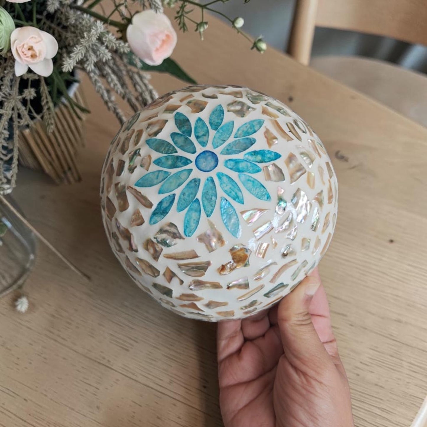 Aqua Bloom Coconut Bowl with aqua floral mother-of-pearl exterior and natural coconut shell base