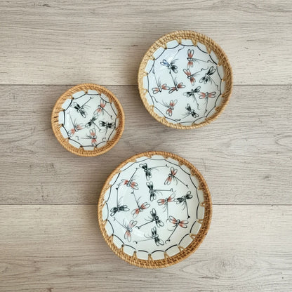 Dragonfly Drift ceramic bowl set with hand-woven rattan rim (small, medium, large) on a wooden surface