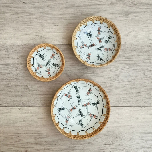 Dragonfly Drift ceramic bowl set with hand-woven rattan rim (small, medium, large) on a wooden surface