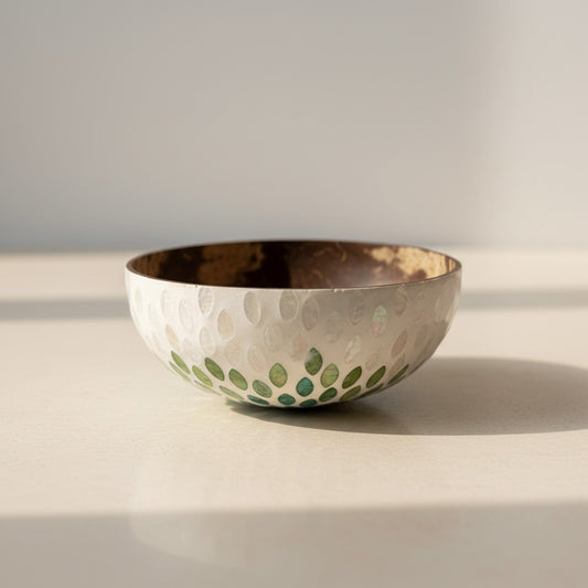 Handcrafted coconut bowl with dark natural shell interior and emerald petal mother-of-pearl exterior