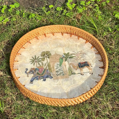 Royal Oasis mother-of-pearl tray with rattan rim photographed outdoors on grass