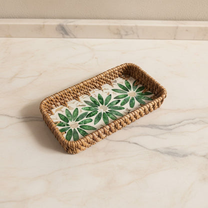 Green Daisy Vanity Tray with green floral mother-of-pearl inlay and woven rattan rim on a light marble surface
