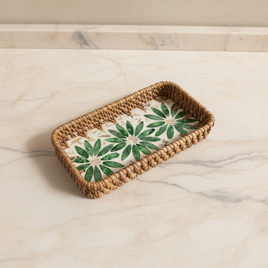 Green Daisy Vanity Tray with green floral mother-of-pearl inlay and woven rattan rim on a light marble surface