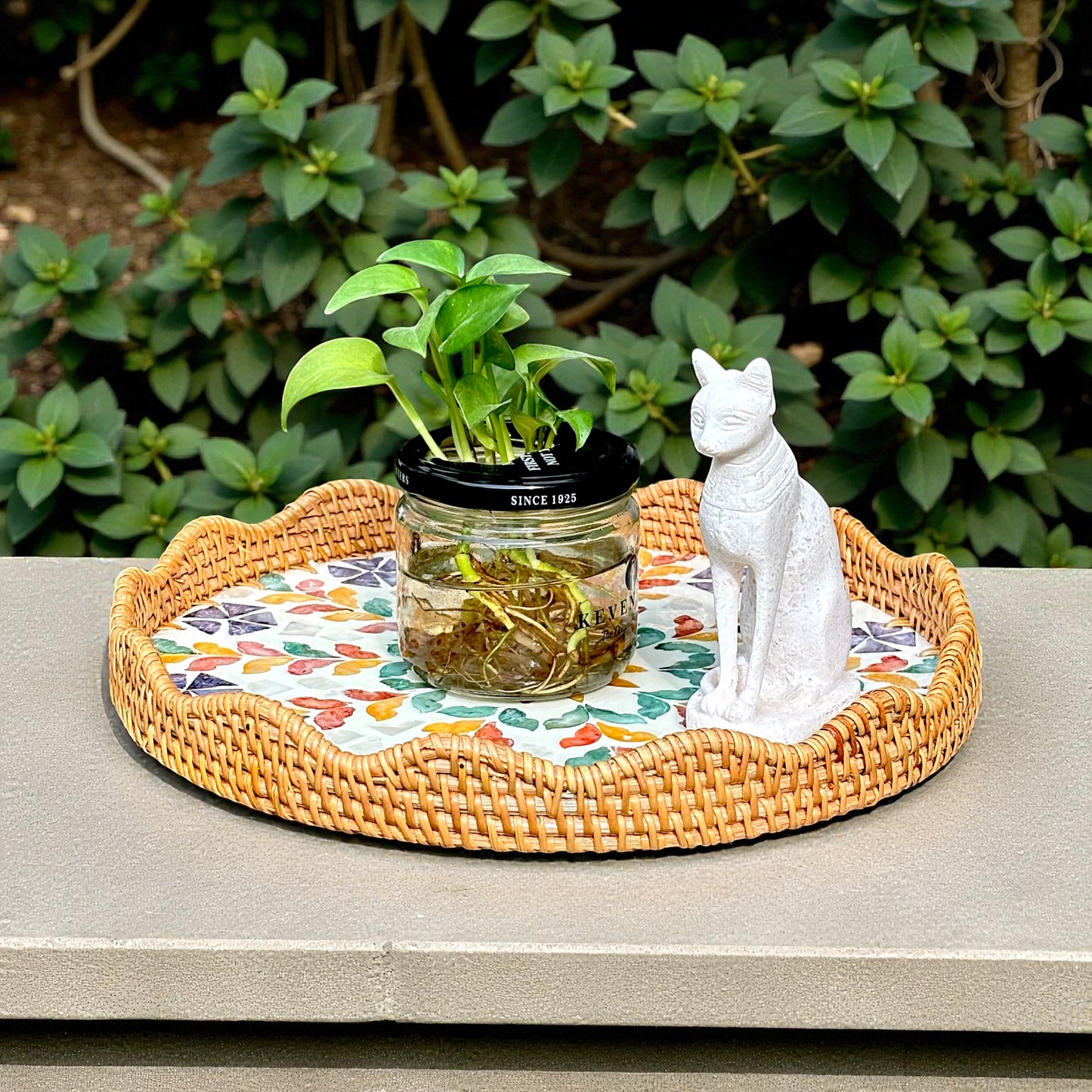Blossom Scalloped Round Tray styled outdoors with a plant and white cat figurine