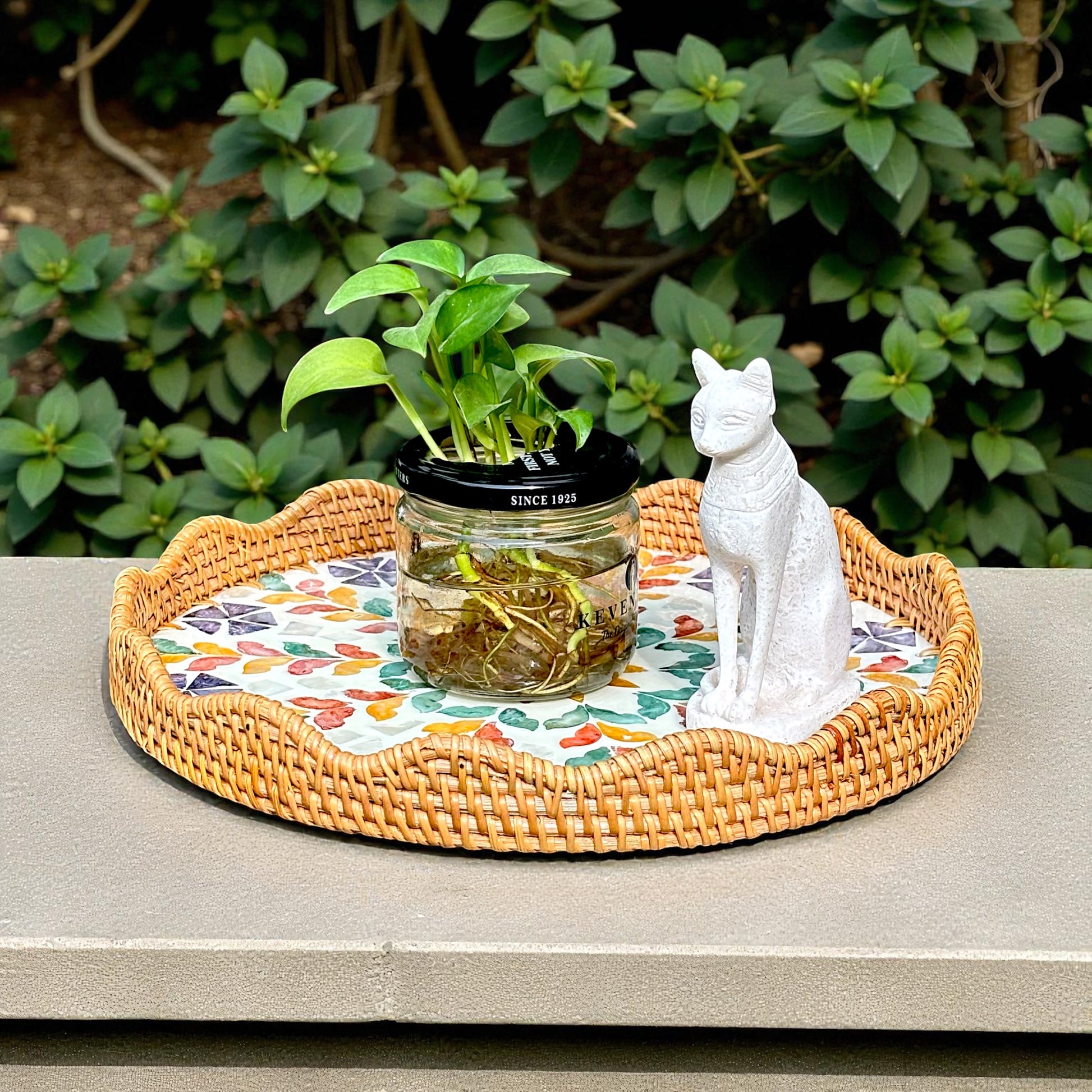 Blossom Scalloped Round Tray styled outdoors with a plant and white cat figurine