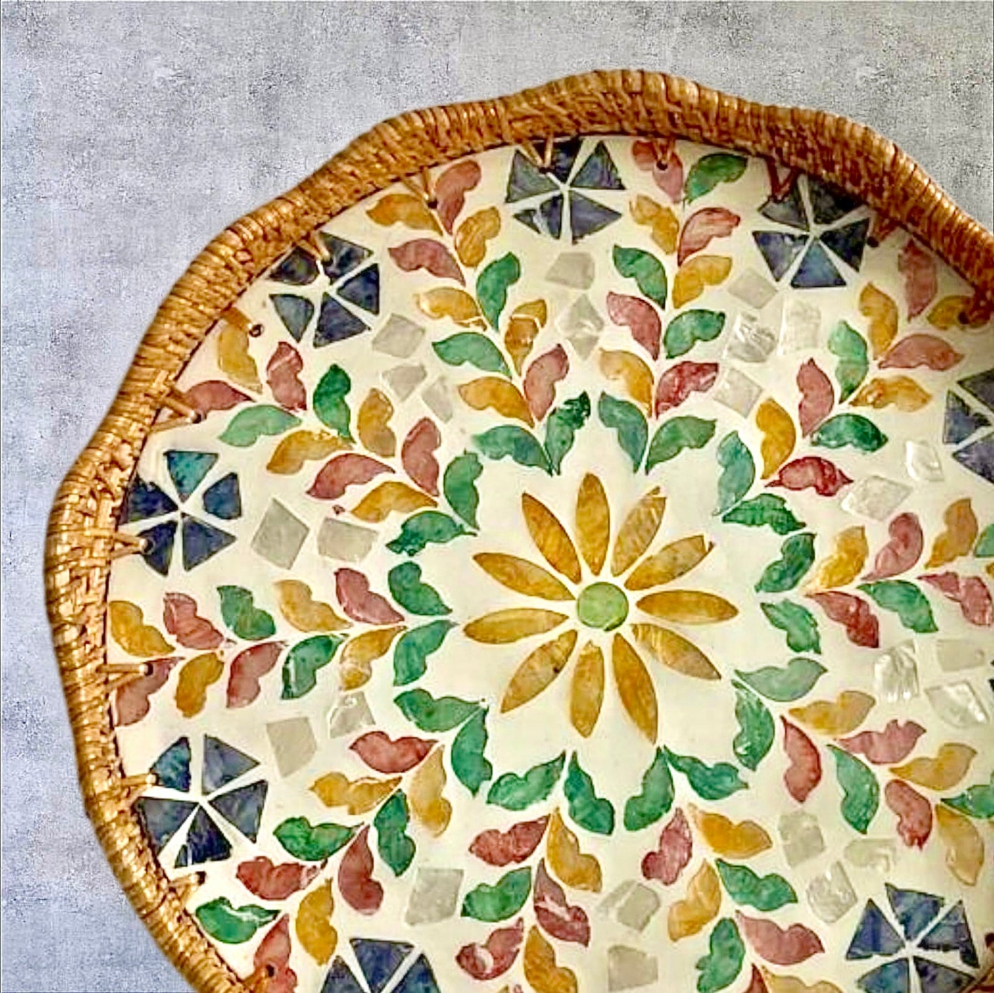 Overhead view of Blossom Scalloped Round Tray showing floral mother-of-pearl pattern on grey surface