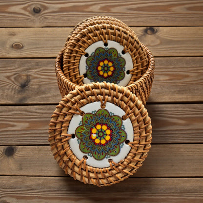 Meadow Mandala Ceramic Rattan Coasters on a wooden centre table background