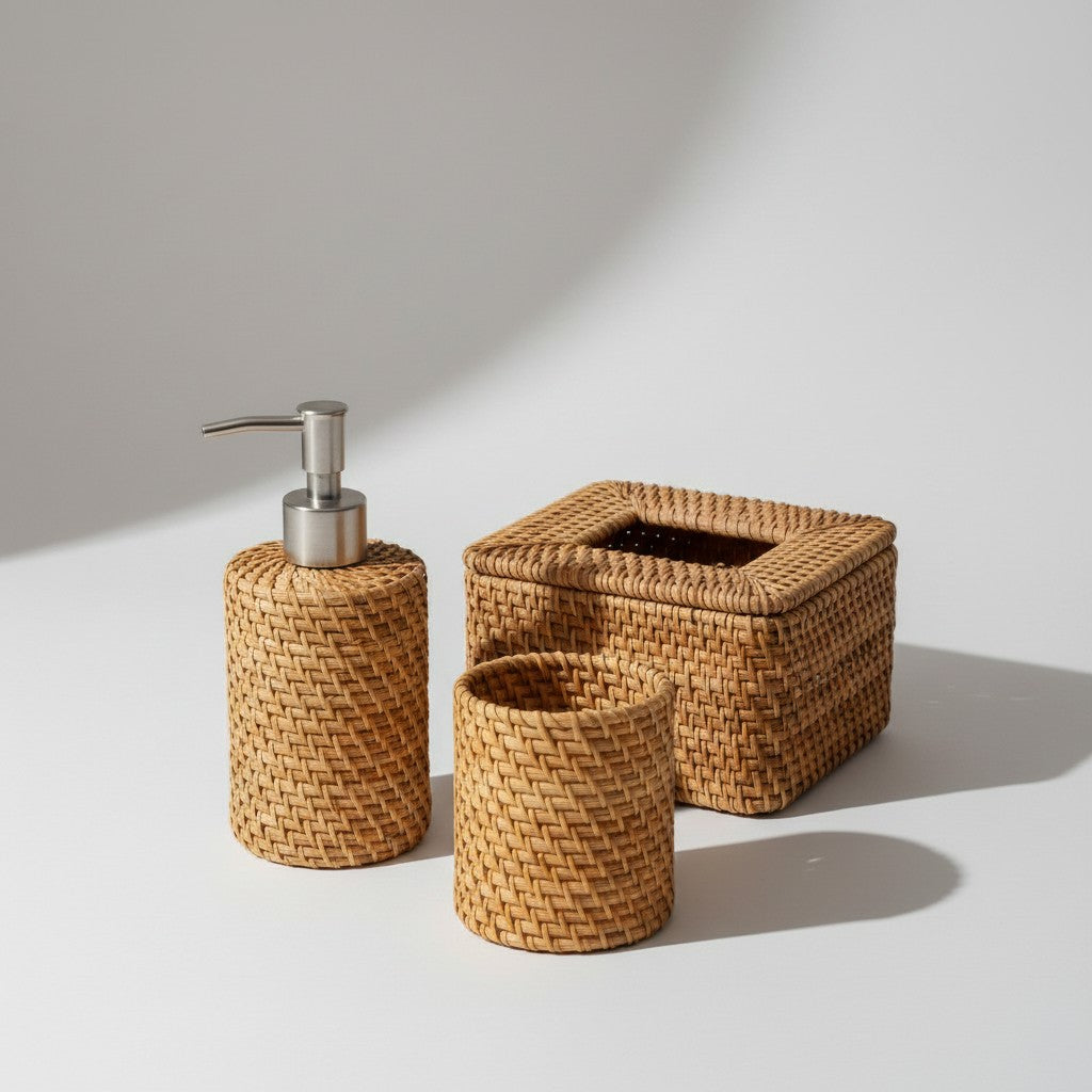 Rattan bathroom counter set with soap dispenser, utility holder and tissue box on a light neutral background