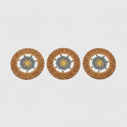 Sunlit Blue rattan coaster set of 3 on light background, blue-yellow mandala ceramic center