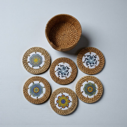 Set of six round rattan coasters with matching woven holder on grey background