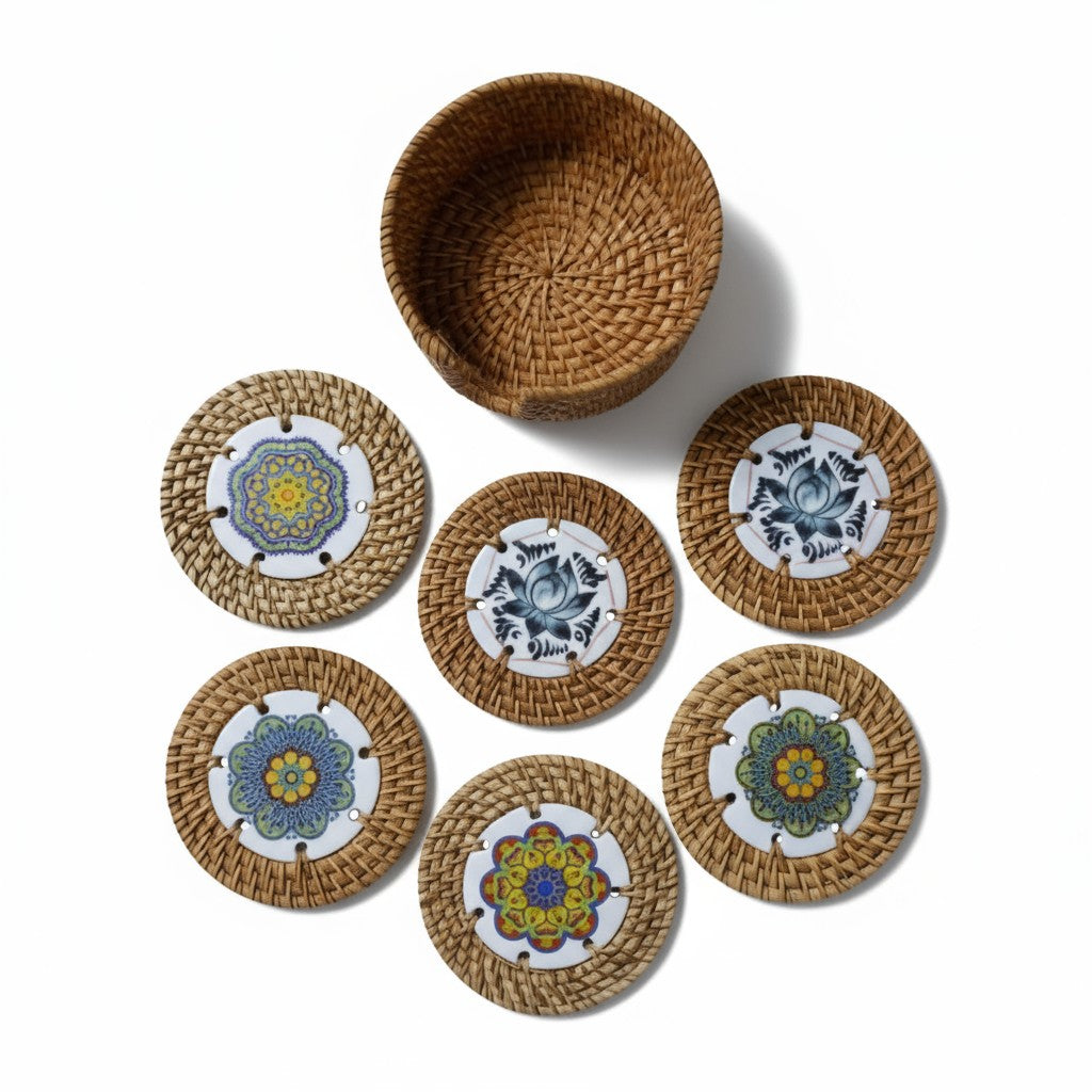 Set of six round rattan coasters with matching woven holder on white background