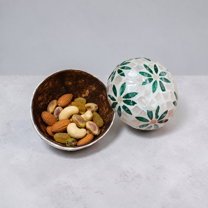 Green Daisy coconut bowl holding dry fruits and nuts