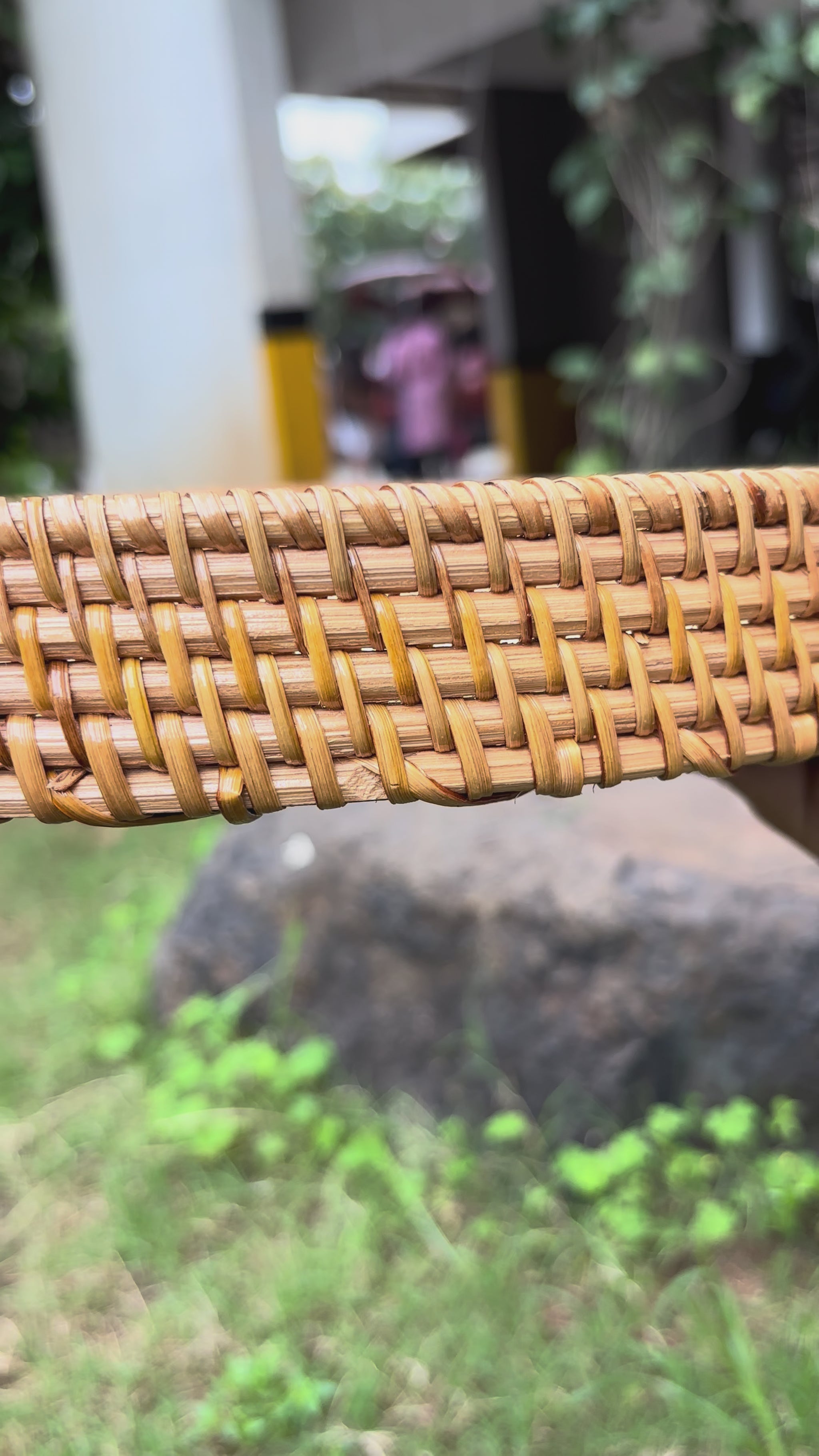Close-up of the hand-woven rattan rim detail on the round decorative tray.